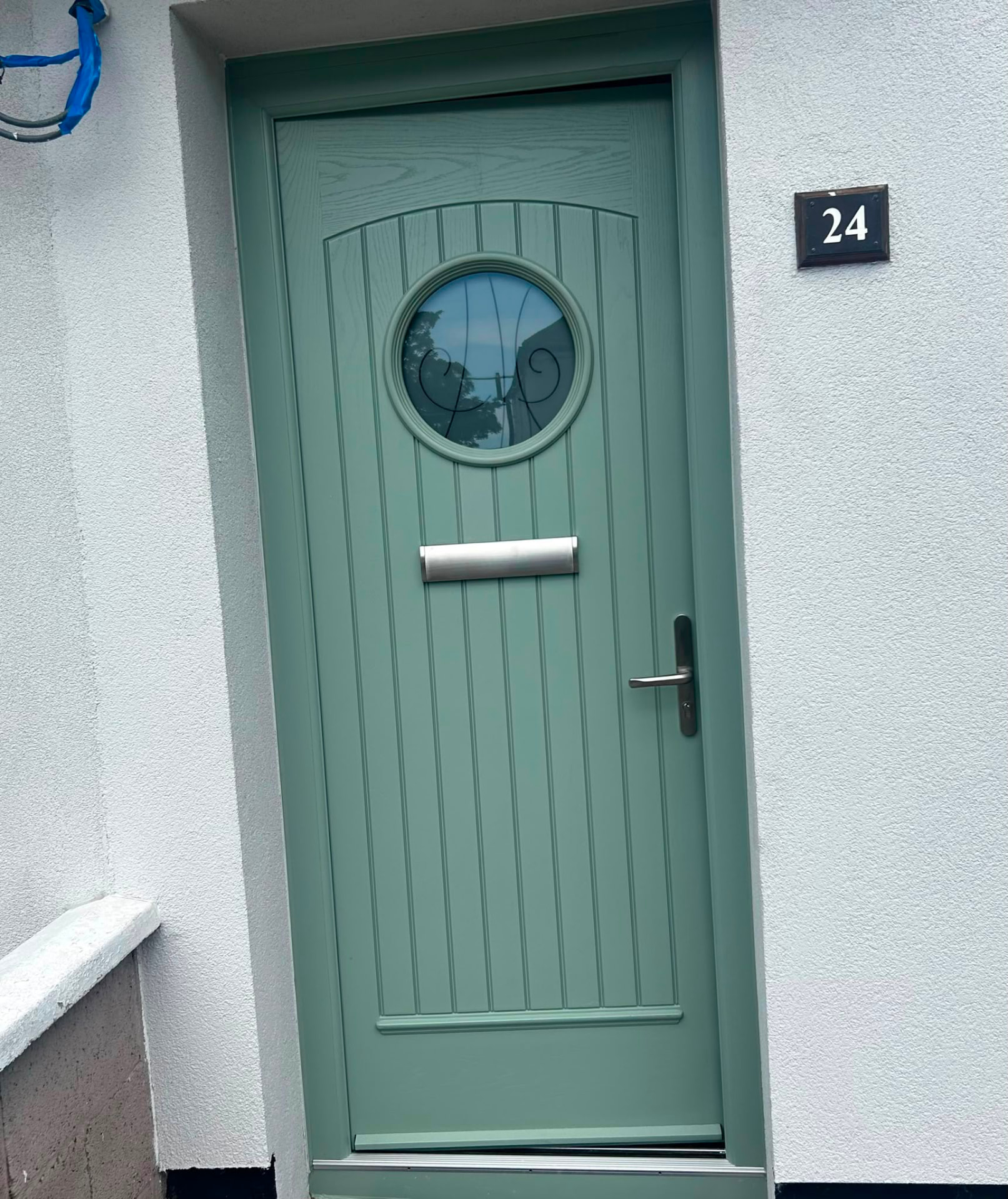 Chartwell green cottage composite front door with round decorative glass panel