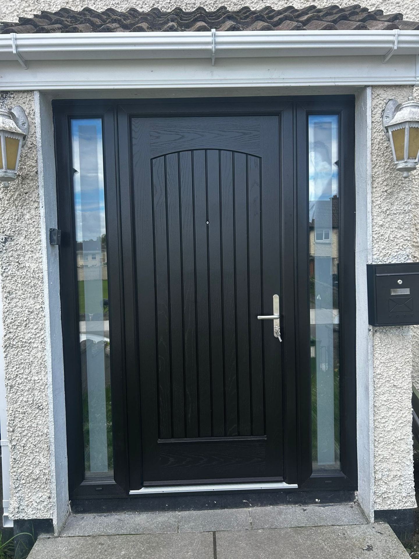 Black cottage style composite front door with full length glazed sidelights
