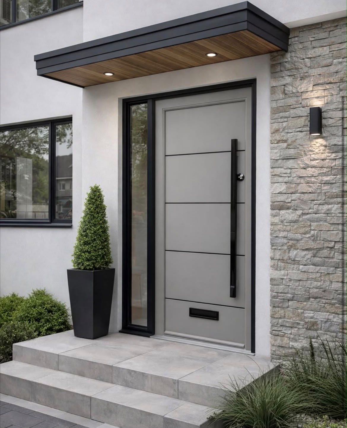 Light grey contemporary front door with black frame, sidelight and bar handle