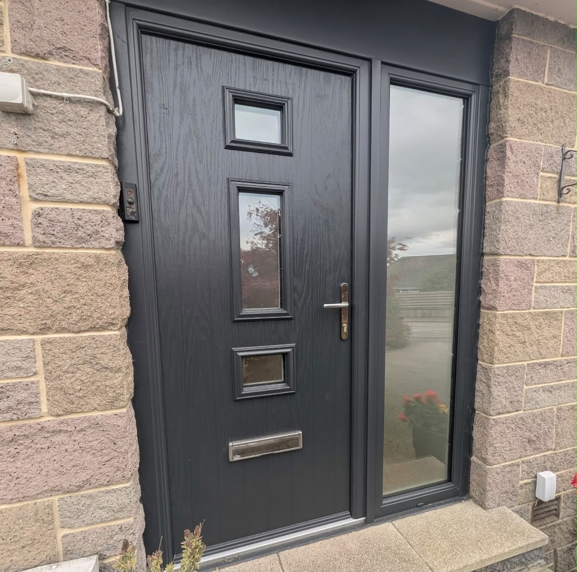 Anthracite composite front door with three square glass panels and sidelight