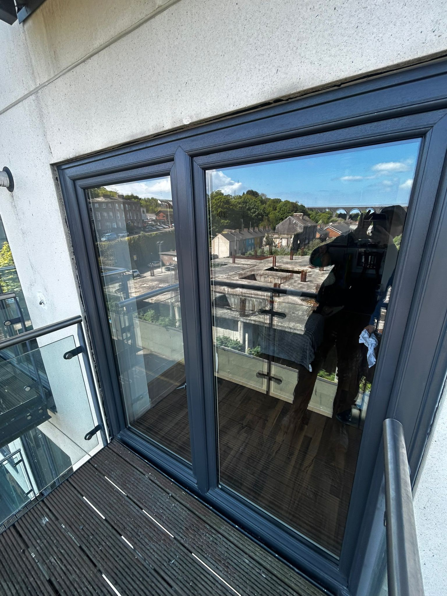 Anthracite grey French doors opening onto an apartment balcony