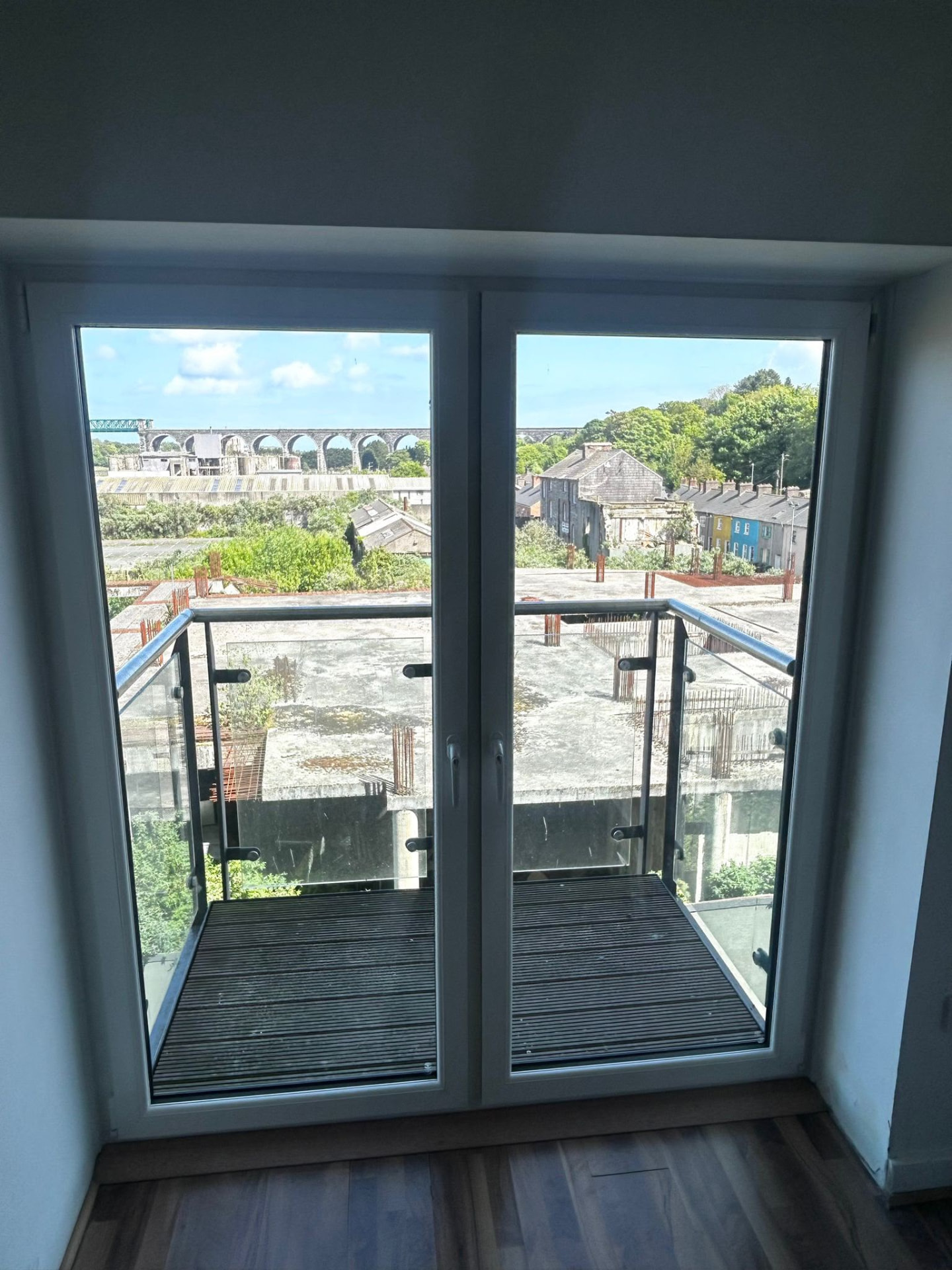 White PVC French doors to a balcony with glass balustrade