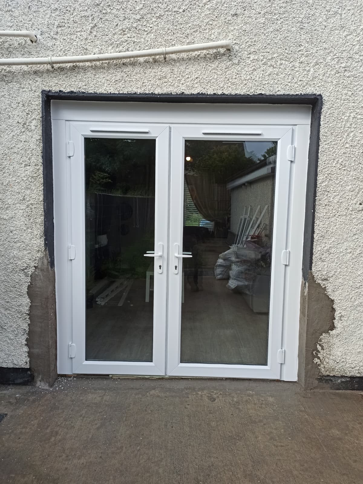 White PVC French doors fitted to a rear extension opening
