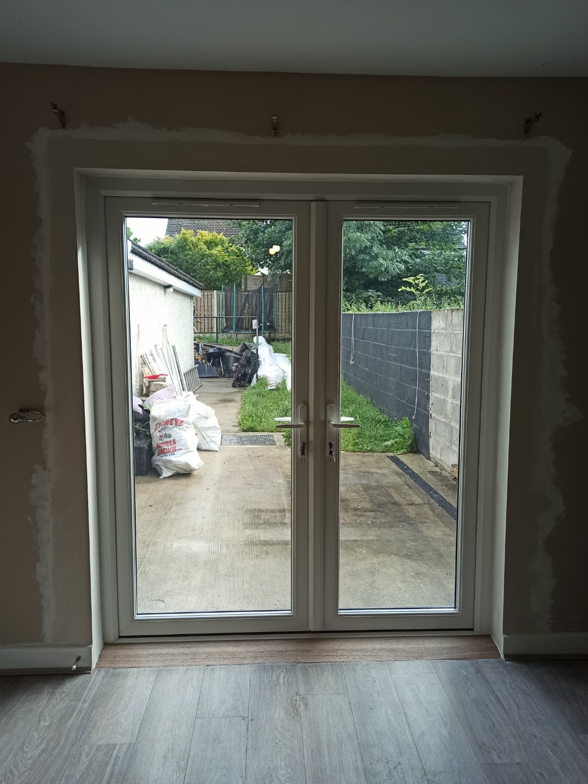 Cream PVC French doors viewed from inside a living room