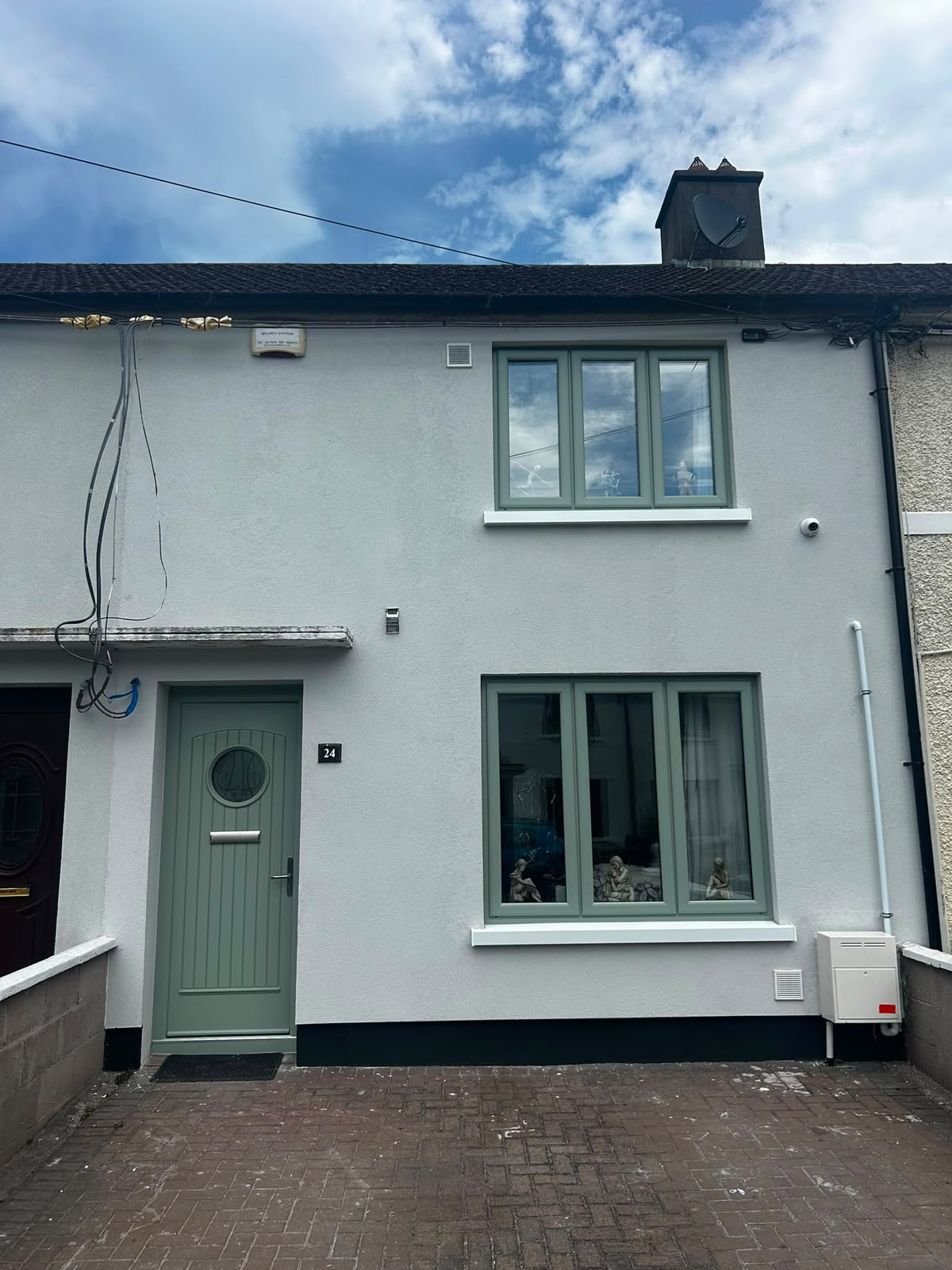 Chartwell green uPVC casement windows and matching front door on a white terraced home in Dublin