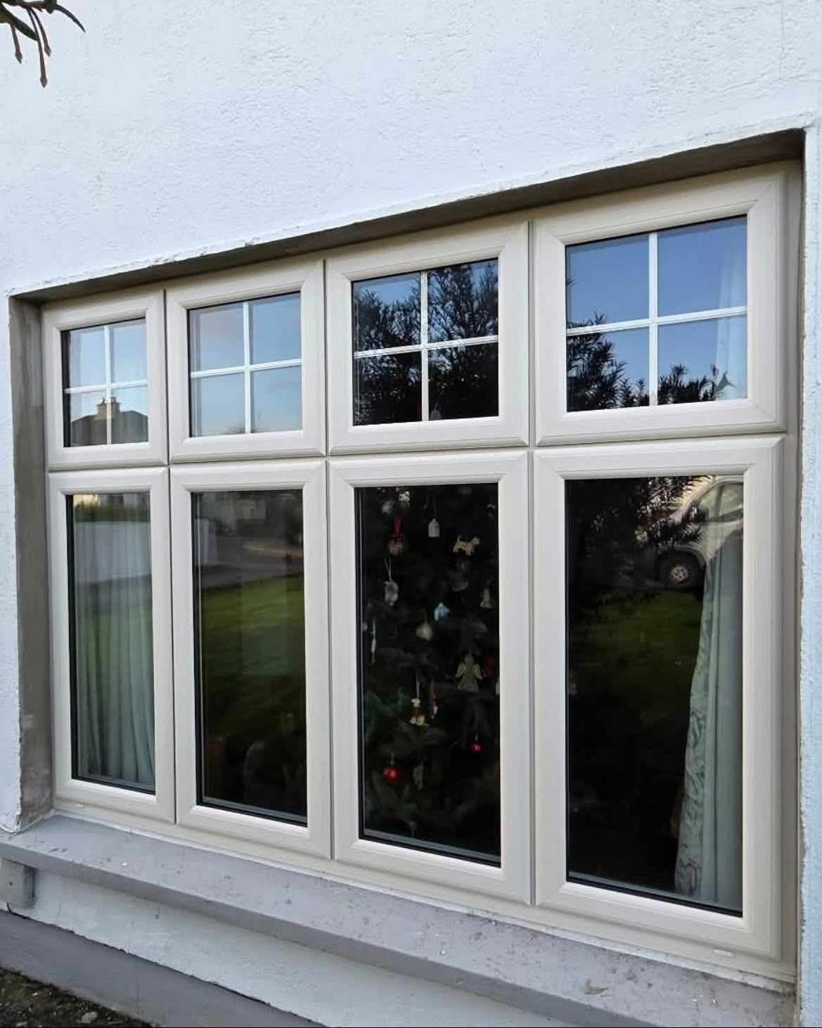 Cream uPVC windows with Georgian bar top openers