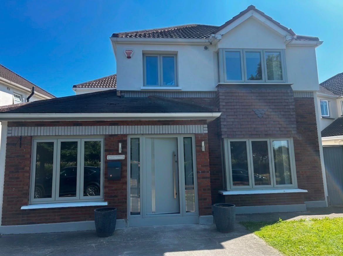 Full front of a detached Dublin home with grey uPVC windows and contemporary front door