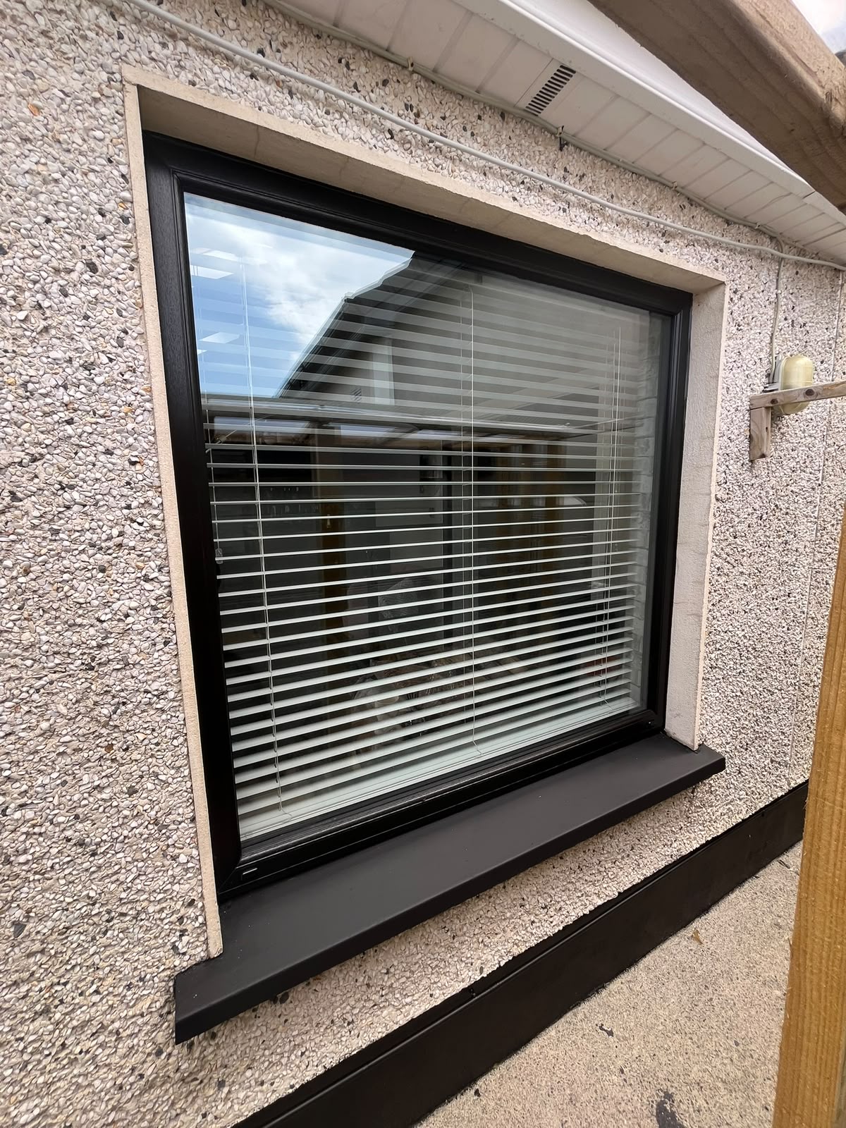 Black uPVC fixed window with matching black sill