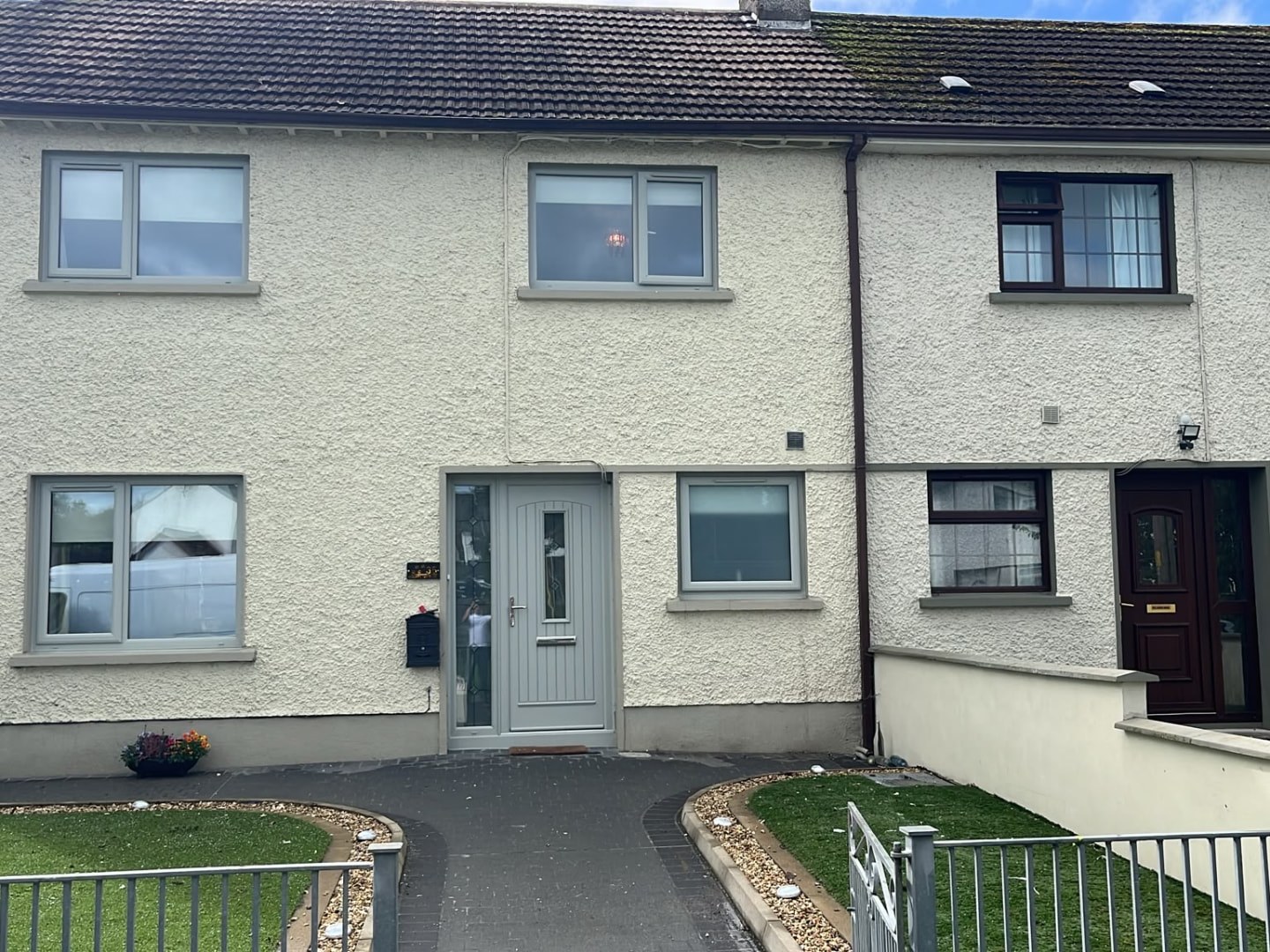 Agate grey uPVC windows and matching front door on a cream rendered Dublin terraced house