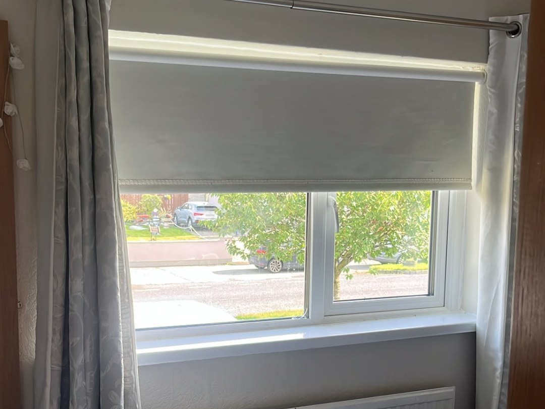 White uPVC casement window with roller blind in a Dublin bedroom
