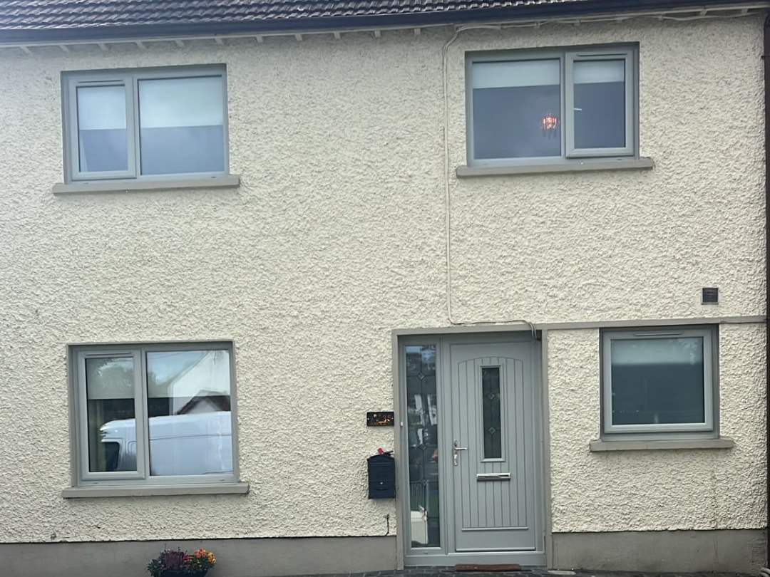 Agate grey uPVC windows and matching front door on a cream rendered two-storey Dublin home