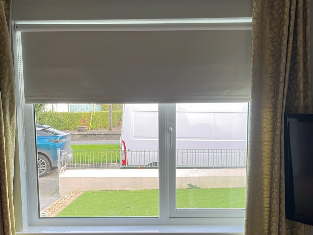 Ground floor white uPVC casement window inside a Dublin home with dual-colour frames
