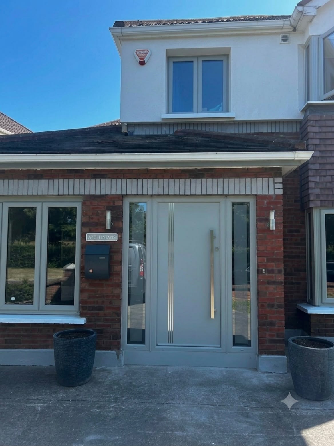 Grey uPVC windows and modern front door with sidelights on a Dublin home