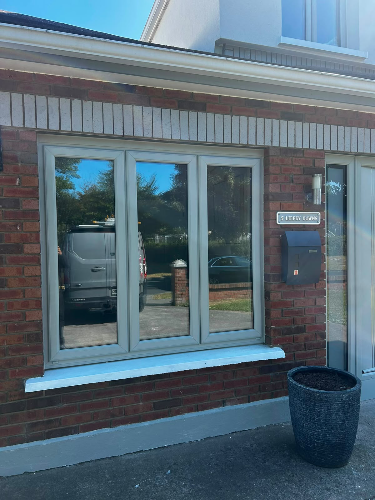 Agate grey triple casement window in a red brick Dublin home